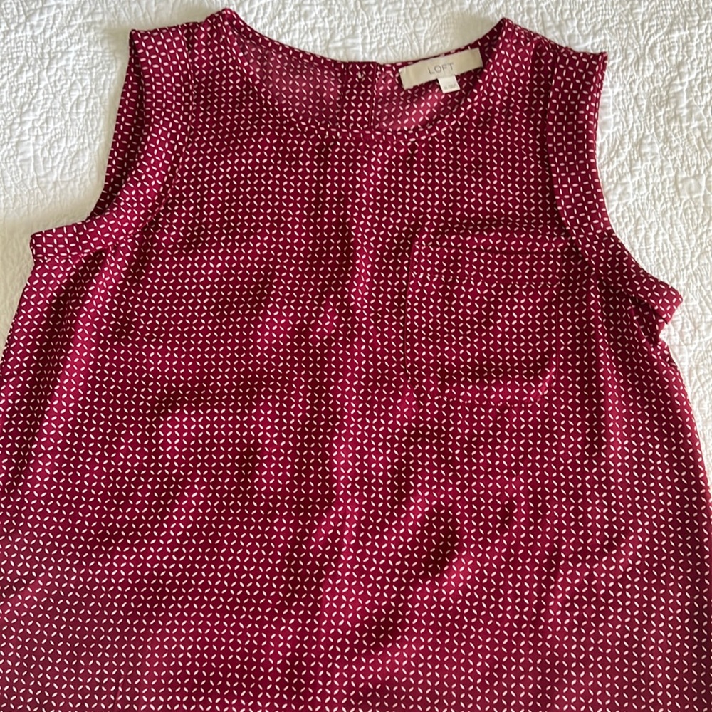 Great sleeveless work blouse with button down back detail